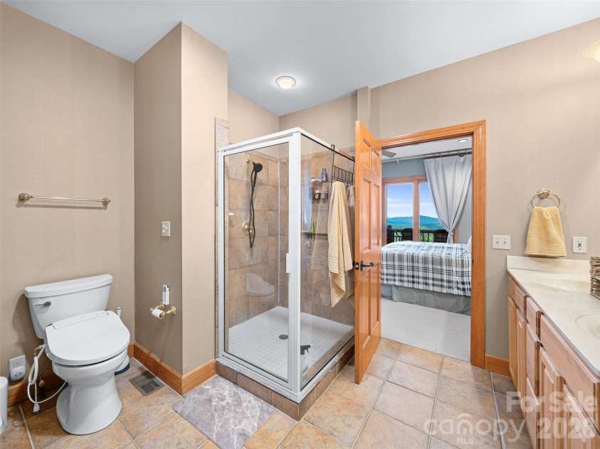 81 Stoney Falls Loop, Burnsville, NC 28714.  MLS# CAR4413097, YatesRealty ID 42820. Glass enclosed shower