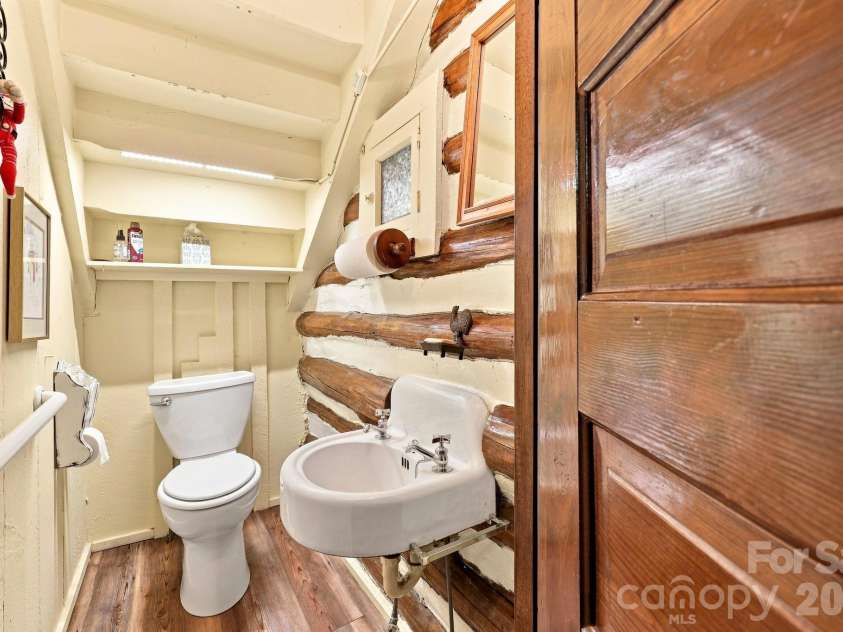 1925 Laurel Park Highway, Hendersonville, NC 28739.  MLS# CAR4410805, YatesRealty ID 42830. 1/2 bath located underneath stairs