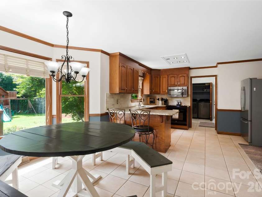 8601 Middleton Circle, Harrisburg, NC 28075.  MLS# CAR4407801, YatesRealty ID 42836. Custom, huge table as you enter the kitchen area (table conveys!)