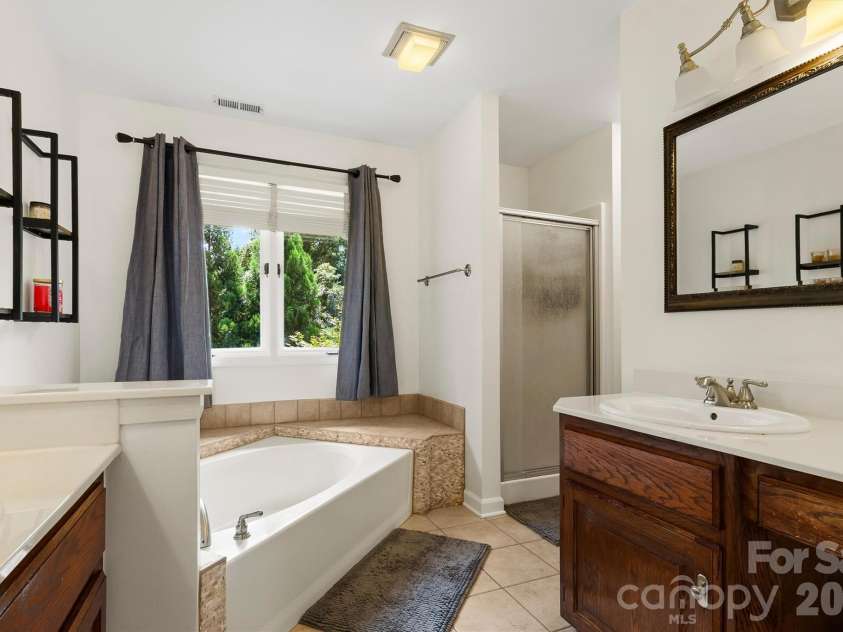 8601 Middleton Circle, Harrisburg, NC 28075.  MLS# CAR4407801, YatesRealty ID 42836. Primary bathroom with 2 sinks, oversized tub & separate shower