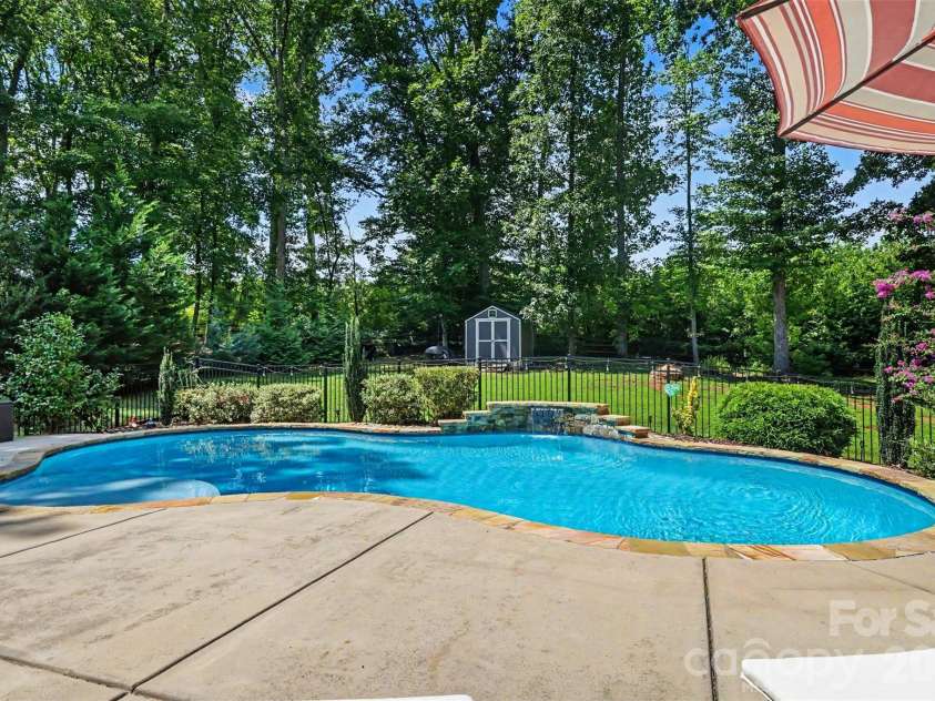1208 High Brook Drive, Waxhaw, NC 28173.  MLS# CAR4409152, YatesRealty ID 42875. Waterfall feature in the heated saltwater pool
