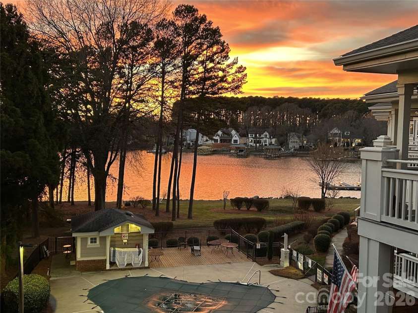 7844 Village Harbor Drive, Cornelius, NC 28031.  MLS# CAR4356496, YatesRealty ID 4288. Sunset view from the deck
