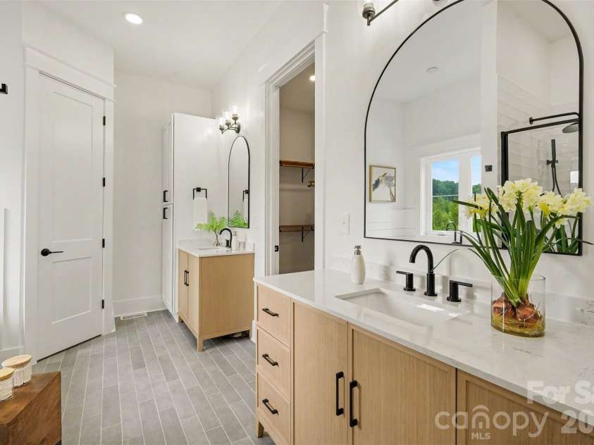 6609 McNeely Road, Waxhaw, NC 28173.  MLS# CAR4366407, YatesRealty ID 42933. And split his-and-her vanities. And linen closet.