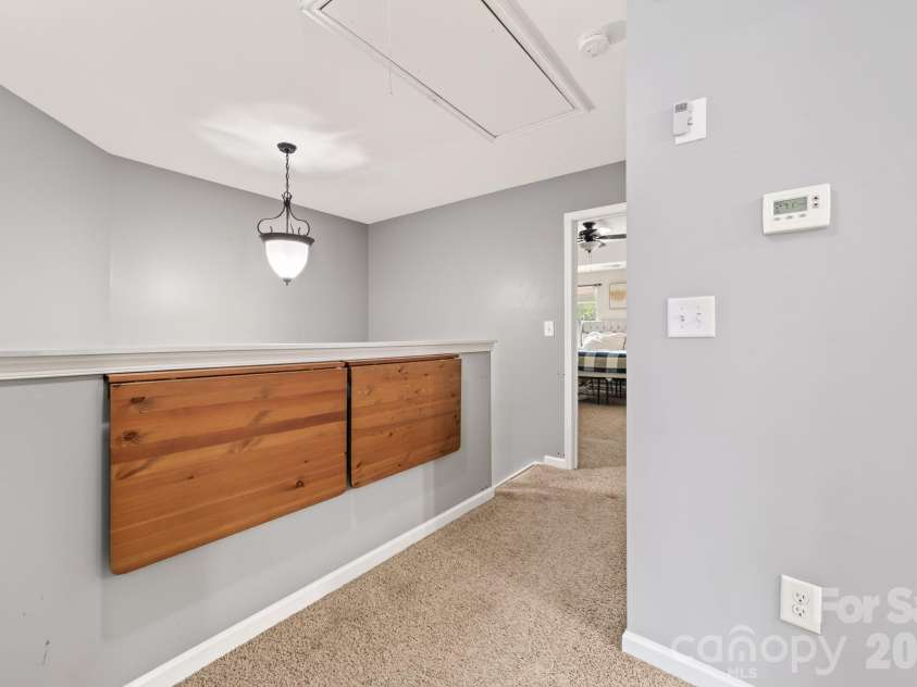 8261 Bridgegate Drive, Huntersville, NC 28078.  MLS# CAR4406688, YatesRealty ID 42936. Upstairs hall with mounted table outside laundry