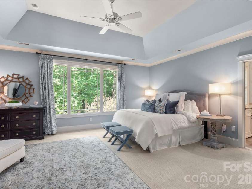 1122 Dobson Drive, Waxhaw, NC 28173.  MLS# CAR4406778, YatesRealty ID 42947. The ultimate owner's retreat, featuring a deep tray ceiling, expansive backyard views, a private sitting area....