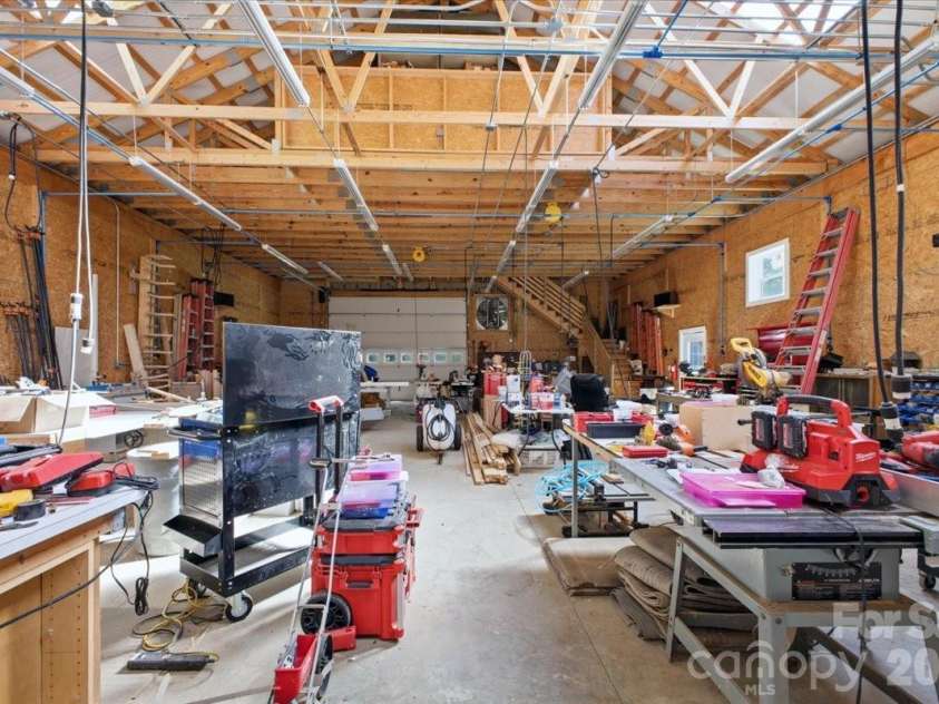 9601 Belt Road, Midland, NC 28107.  MLS# CAR4412563, YatesRealty ID 42969. Garage Workshop interior. Stairs to loft at the back.