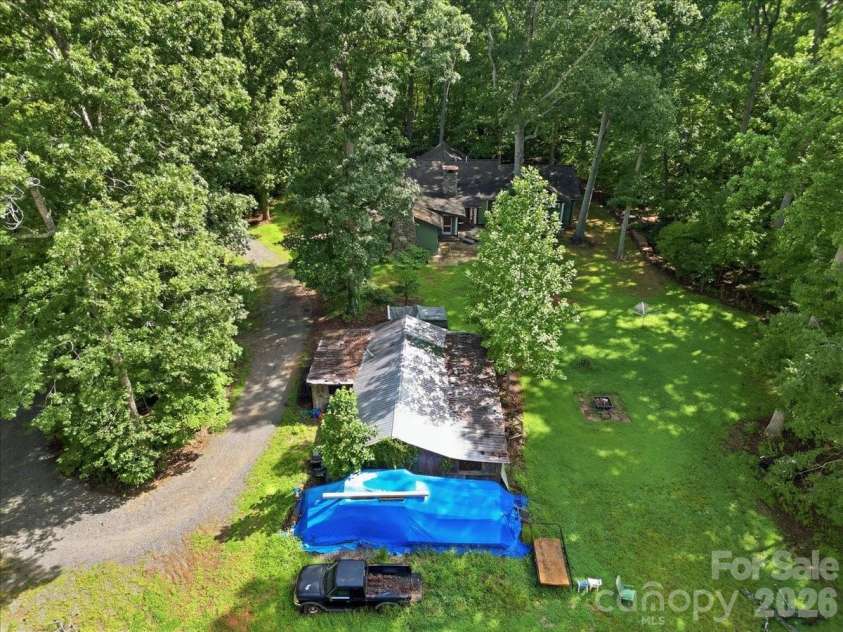 9601 Belt Road, Midland, NC 28107.  MLS# CAR4412563, YatesRealty ID 42969. House in back and old horse barn