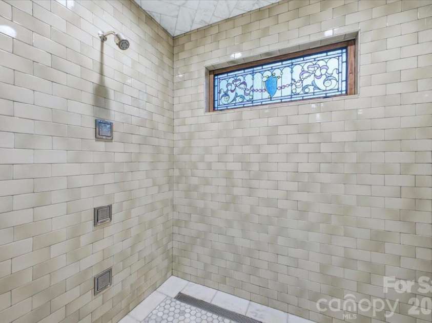 9601 Belt Road, Midland, NC 28107.  MLS# CAR4412563, YatesRealty ID 42969. Primary shower with leaded glass feature
