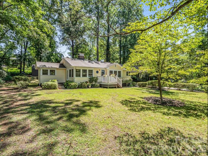 117 Whitney Avenue, Tryon, NC 28782.  MLS# CAR4400518, YatesRealty ID 42984. Patio on the left and level front yard with mature trees