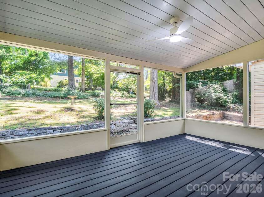 117 Whitney Avenue, Tryon, NC 28782.  MLS# CAR4400518, YatesRealty ID 42984. Screen porch with ceiling fan/light has easy access to the level back yard