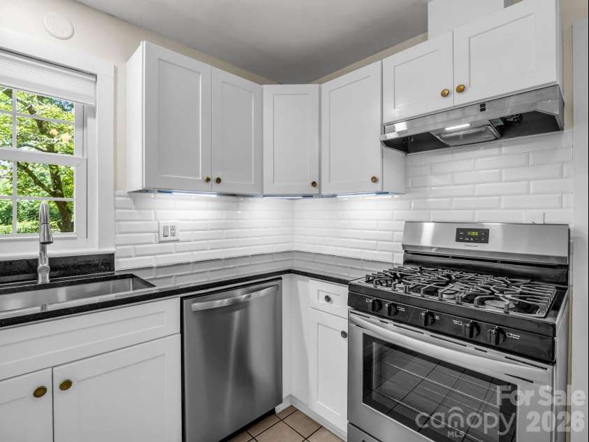 117 Whitney Avenue, Tryon, NC 28782.  MLS# CAR4400518, YatesRealty ID 42984. Under counter lighting and gas range oven
