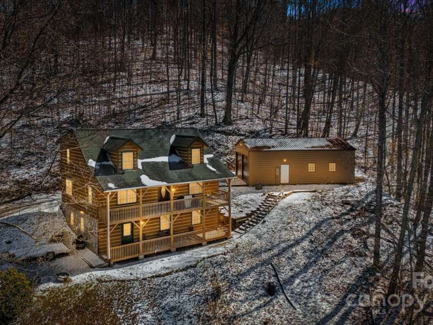 110 Red Wolf Lane, Mars Hill, NC 28754.  MLS# CAR4239848, YatesRealty ID 4299. Evening view of the house and garage