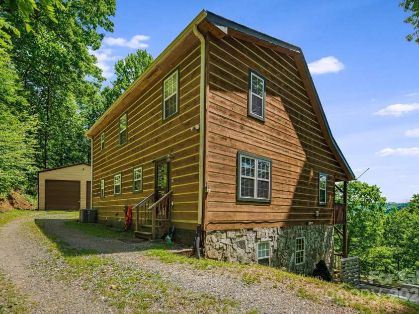 110 Red Wolf Lane, Mars Hill, NC 28754.  MLS# CAR4239848, YatesRealty ID 4299. Side view of house and garage