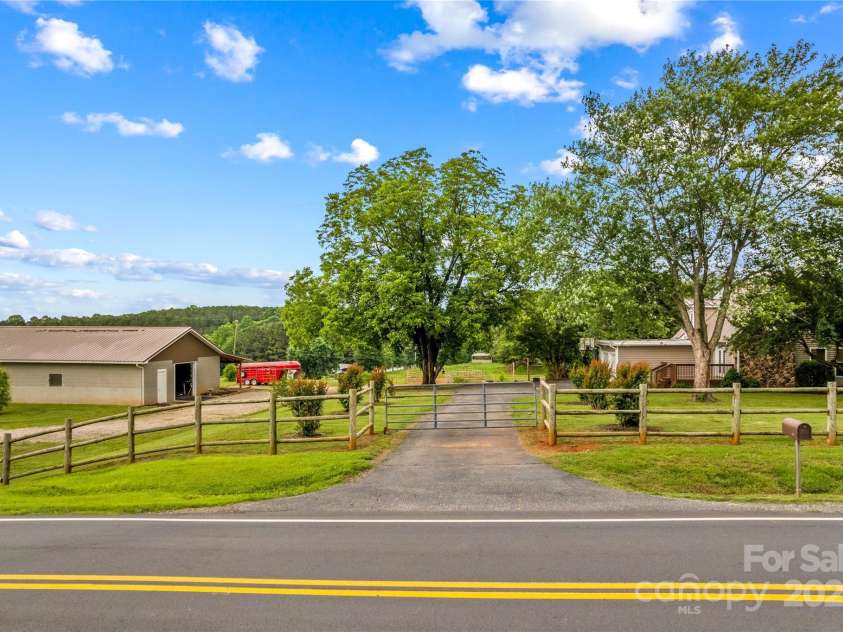 296 Hicks Creek Road, Troutman, NC 28166.  MLS# CAR4266143, YatesRealty ID 430. Gated Entrance. The Home and Acreage is fully Fenced