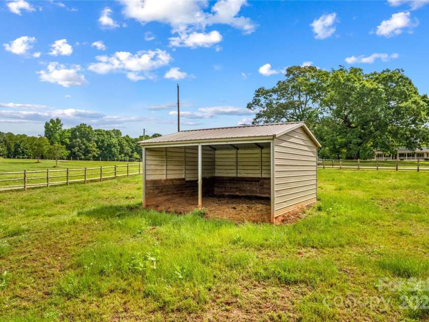 296 Hicks Creek Road, Troutman, NC 28166.  MLS# CAR4266143, YatesRealty ID 430. Run In Shed in Pasture