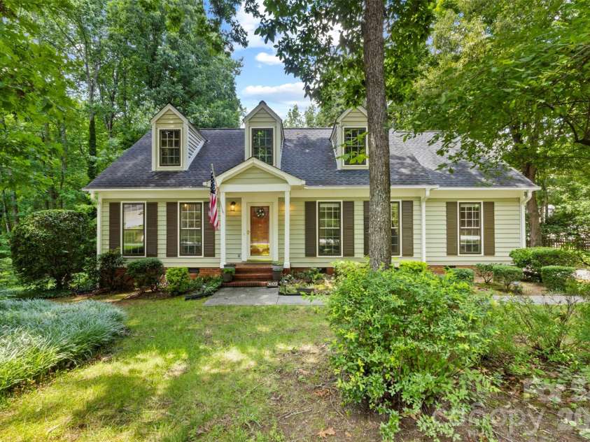 3022 Butter Churn Lane, Matthews, NC 28105.  MLS# CAR4411109, YatesRealty ID 43021. Front Exterior – Charming front elevation with classic architectural details, mature landscaping, and a welcoming covered entry.