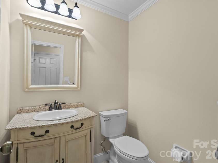 3022 Butter Churn Lane, Matthews, NC 28105.  MLS# CAR4411109, YatesRealty ID 43021. Powder Room – Convenient main-level half bath with vanity and updated lighting.