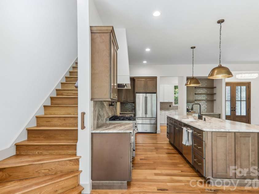318 Mountain Home Trail, Brevard, NC 28712.  MLS# CAR4405578, YatesRealty ID 43041. Kitchen and stairs to second story