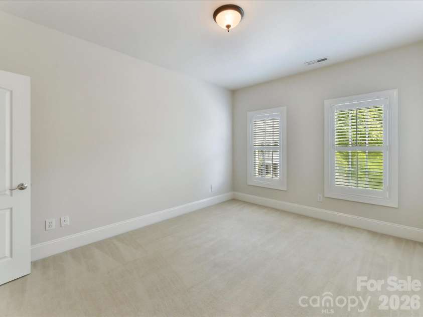 439 O'Henry Avenue, Davidson, NC 28036.  MLS# CAR4409491, YatesRealty ID 43051. Bedroom 2 on upper level with great natural light.