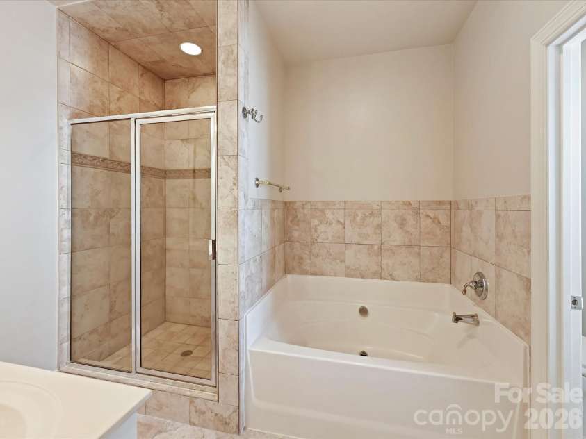 439 O'Henry Avenue, Davidson, NC 28036.  MLS# CAR4409491, YatesRealty ID 43051. Primary Bath with a large soaking tub & separate, tiled shower.
