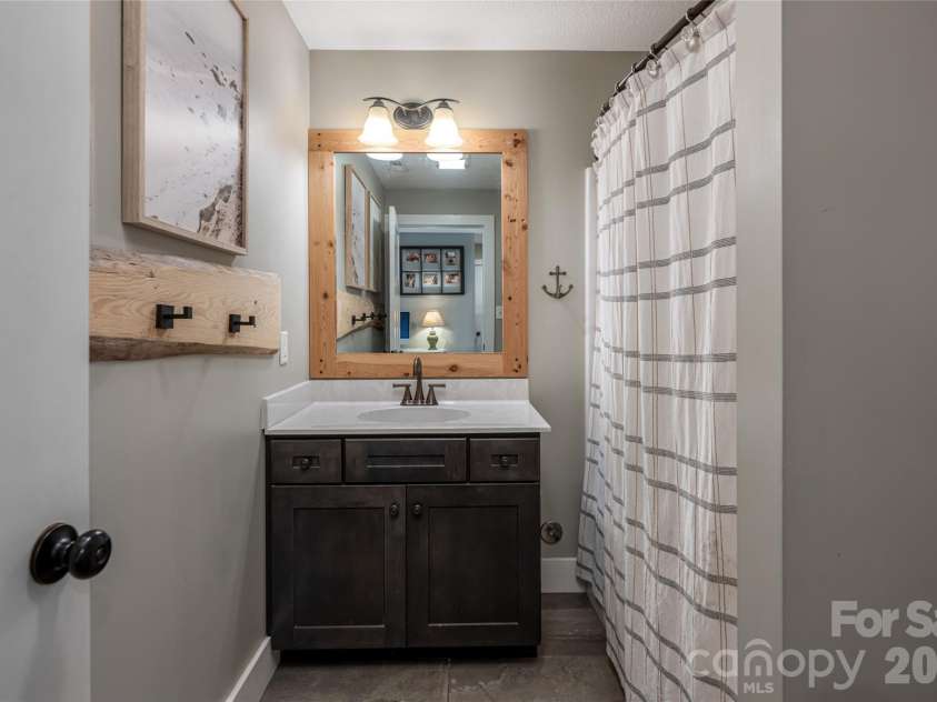 11 Ibbie Roberts Road, Alexander, NC 28701.  MLS# CAR4396356, YatesRealty ID 43060. Lower Level Guest Bathroom