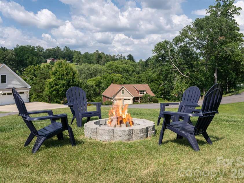 11 Ibbie Roberts Road, Alexander, NC 28701.  MLS# CAR4396356, YatesRealty ID 43060. Relaxing Fire Pit overlooking the rolling hills