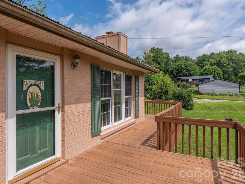 69 Emerald Lane, Hendersonville, NC 28792.  MLS# CAR4405038, YatesRealty ID 43085. Tons of decking for entertaining or resting