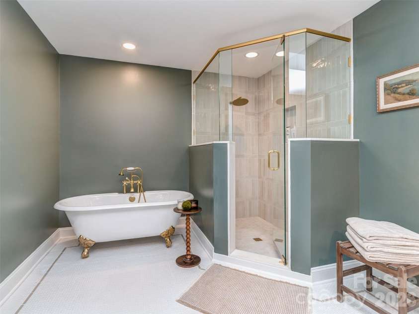 6129 Page Court, Charlotte, NC 28270.  MLS# CAR4408217, YatesRealty ID 43087. Exceptionally Expanded & Designed New Primary Bath with Custom Vanity, Sconce & Recessed Lighting, Custom Tile Flooring with In-Lays, Claw Foot Soaking Tub, & Walk-In Shower.