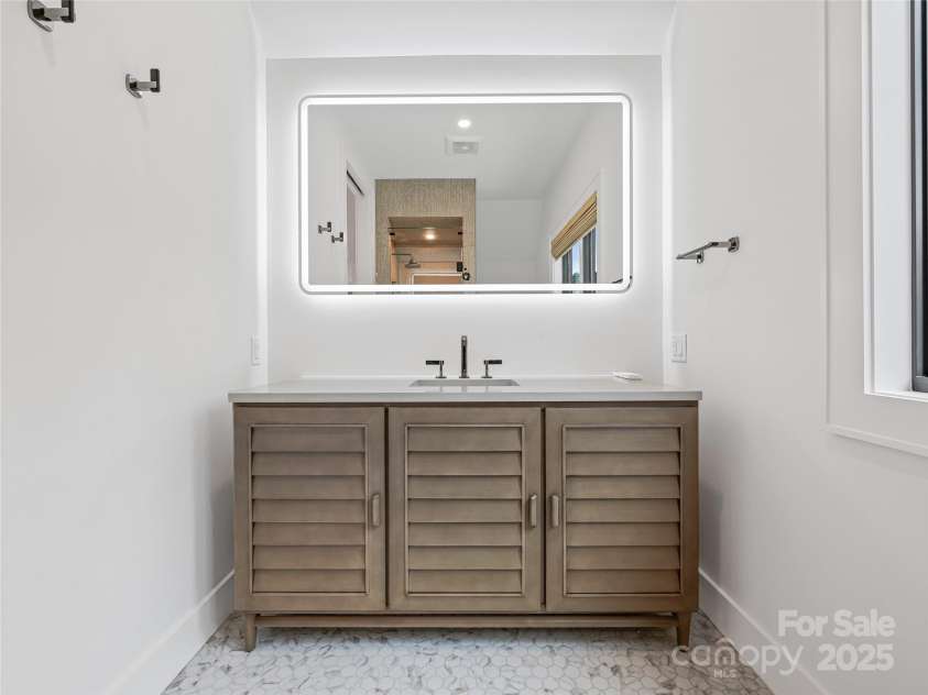 165 Robinhood Road, Asheville, NC 28804.  MLS# CAR4240751, YatesRealty ID 4309. A thoughtfully designed en suite with radiant floor heat and artful tile throughout