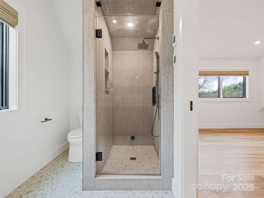 165 Robinhood Road, Asheville, NC 28804.  MLS# CAR4240751, YatesRealty ID 4309. Experience total comfort with a steam shower and warm tile underfoot, thanks to in-floor radiant heat