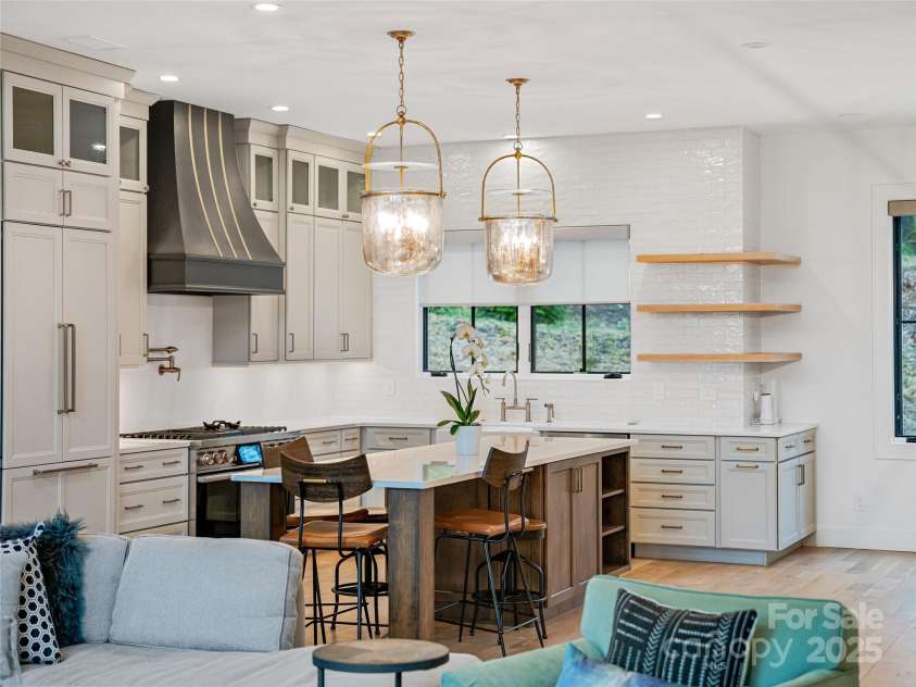 165 Robinhood Road, Asheville, NC 28804.  MLS# CAR4240751, YatesRealty ID 4309. The heart of the home—featuring a large quartz island and beautifully crafted custom cabinetry