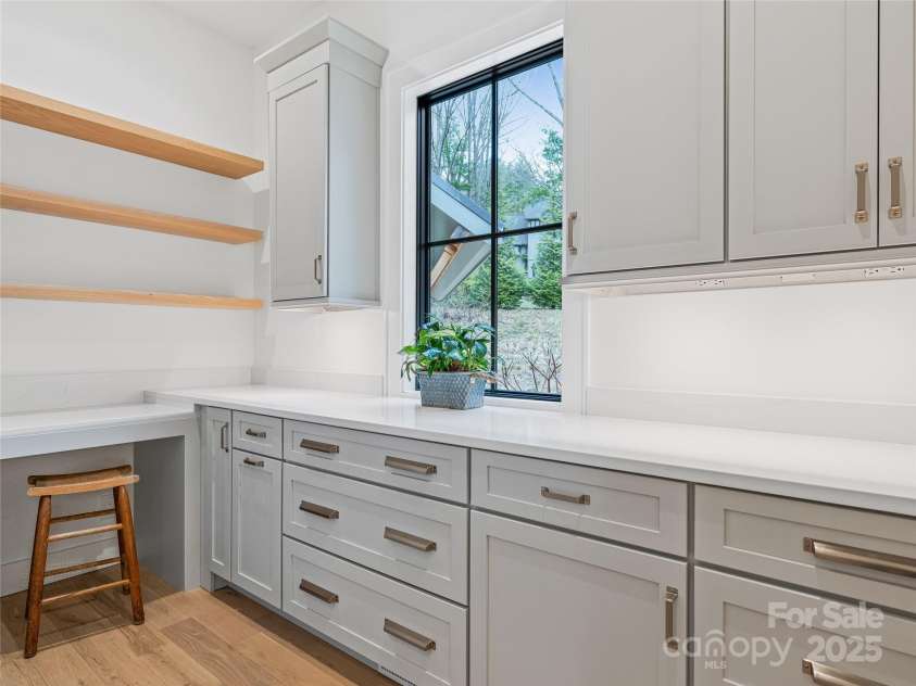 165 Robinhood Road, Asheville, NC 28804.  MLS# CAR4240751, YatesRealty ID 4309. This walk-in butler’s pantry doubles as a flexible work zone, complete with abundant storage and counter space