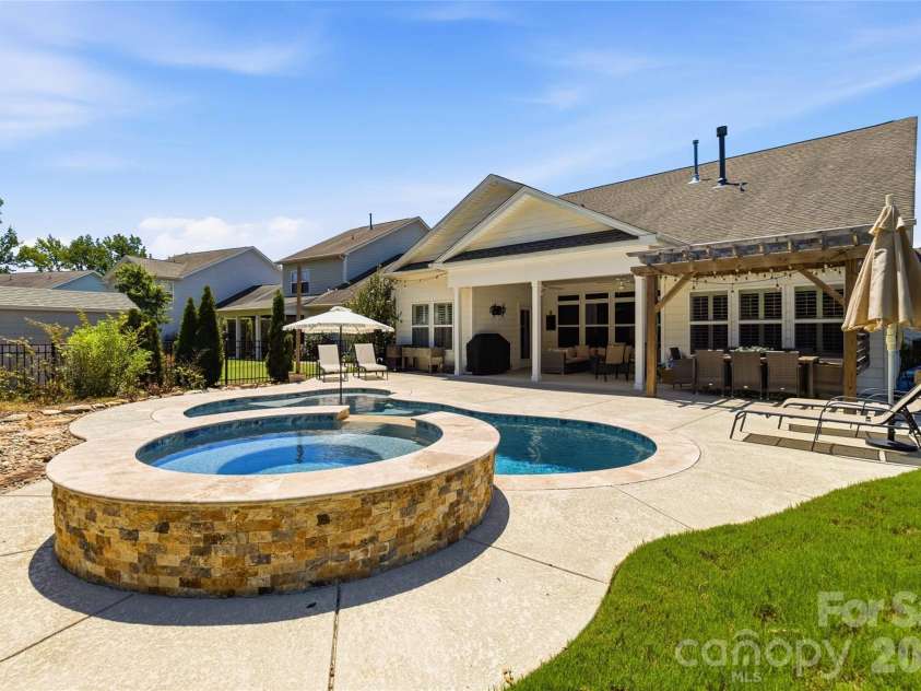 4108 Bent Green Lane, Monroe, NC 28112.  MLS# CAR4411876, YatesRealty ID 43129. Heated spa overflows into the pool