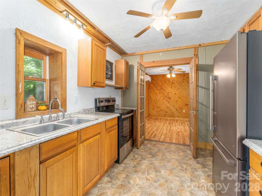 3543 Dark Ridge Road, Sylva, NC 28779.  MLS# CAR4410870, YatesRealty ID 43138. Lower Level Kitchen into guest space