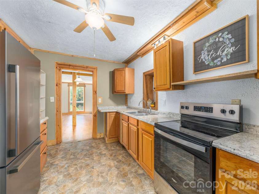 3543 Dark Ridge Road, Sylva, NC 28779.  MLS# CAR4410870, YatesRealty ID 43138. Lower level kitchen into living room