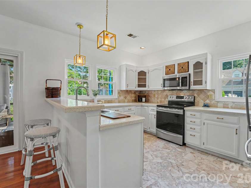 17205 Asti Court, Cornelius, NC 28031.  MLS# CAR4406087, YatesRealty ID 43276. Kitchen with SS appliances.