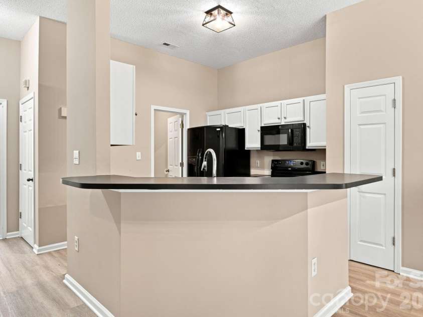 7632 Free Bird Avenue, Charlotte, NC 28216.  MLS# CAR4411446, YatesRealty ID 43281. Back to the kitchen looking...