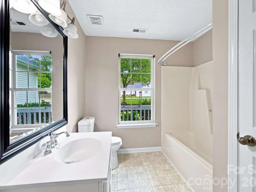 7632 Free Bird Avenue, Charlotte, NC 28216.  MLS# CAR4411446, YatesRealty ID 43281. Hall bath for secondary bedrooms and guests