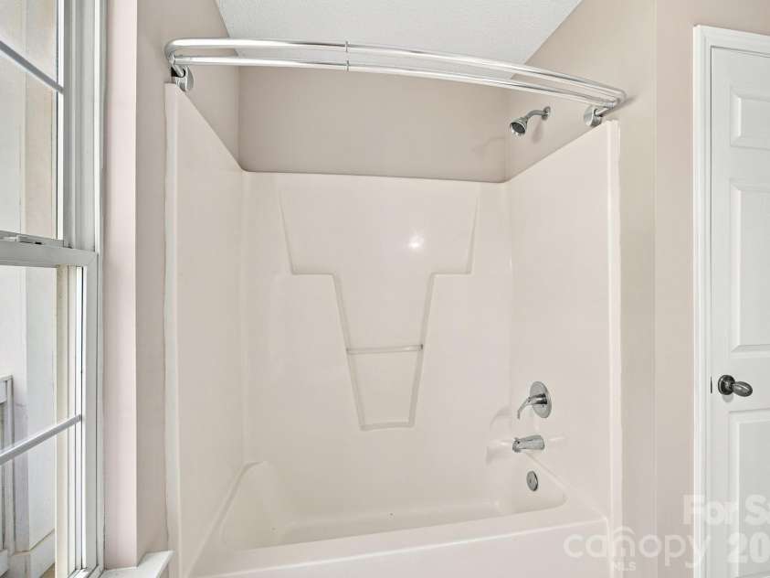 7632 Free Bird Avenue, Charlotte, NC 28216.  MLS# CAR4411446, YatesRealty ID 43281. Shower/tub combo with convenient linen closet