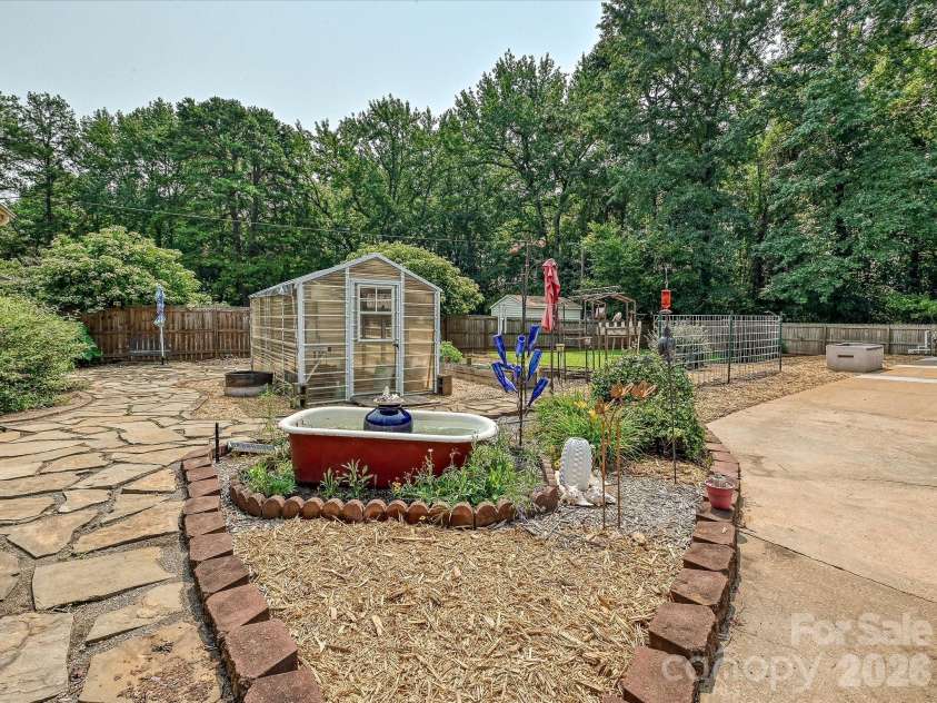 8812 Crestwood Drive, Mount Pleasant, NC 28124.  MLS# CAR4408679, YatesRealty ID 43303. Greenhouse and gardens