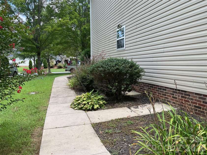 935 Wind Carved Lane, Monroe, NC 28110.  MLS# CAR4412937, YatesRealty ID 43358. Walkway on side
