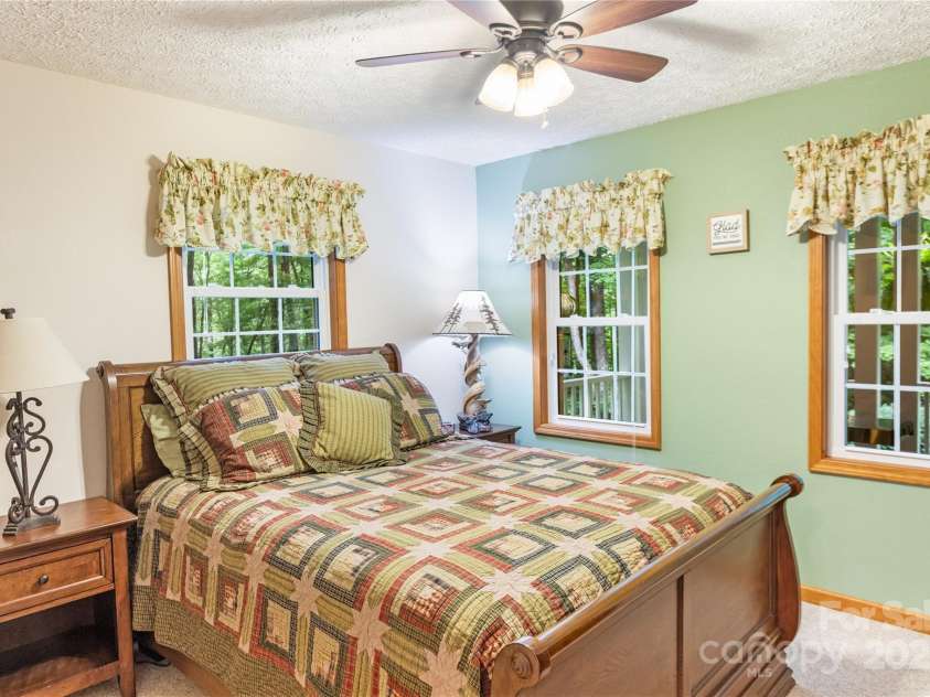 93 Hickory Drive, Maggie Valley, NC 28751.  MLS# CAR4290605, YatesRealty ID 4338. Bedroom 3 enjoys view of lush backyard