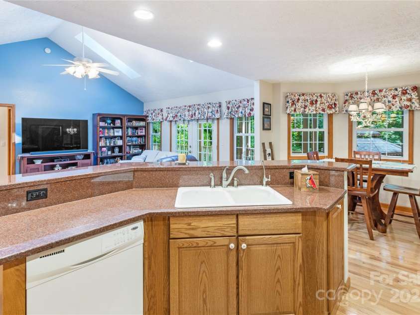 93 Hickory Drive, Maggie Valley, NC 28751.  MLS# CAR4290605, YatesRealty ID 4338. Kitchen with island and breakfast bar seating