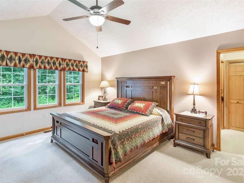 93 Hickory Drive, Maggie Valley, NC 28751.  MLS# CAR4290605, YatesRealty ID 4338. Spacious primary bedroom with deck access