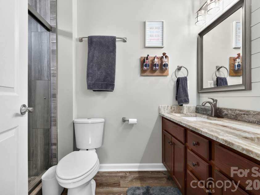 38 Swift Creek Road, Fletcher, NC 28732.  MLS# CAR4413566, YatesRealty ID 43429. Primary bath with vaulted ceiling and tile shower