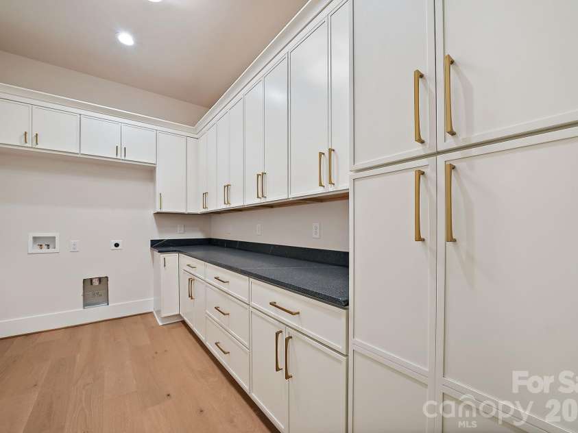 21617 Rio Oro Drive, Cornelius, NC 28031.  MLS# CAR4411277, YatesRealty ID 43438. Tucked seamlessly off the primary suite, this well appointed laundry room blends function with high-end style.