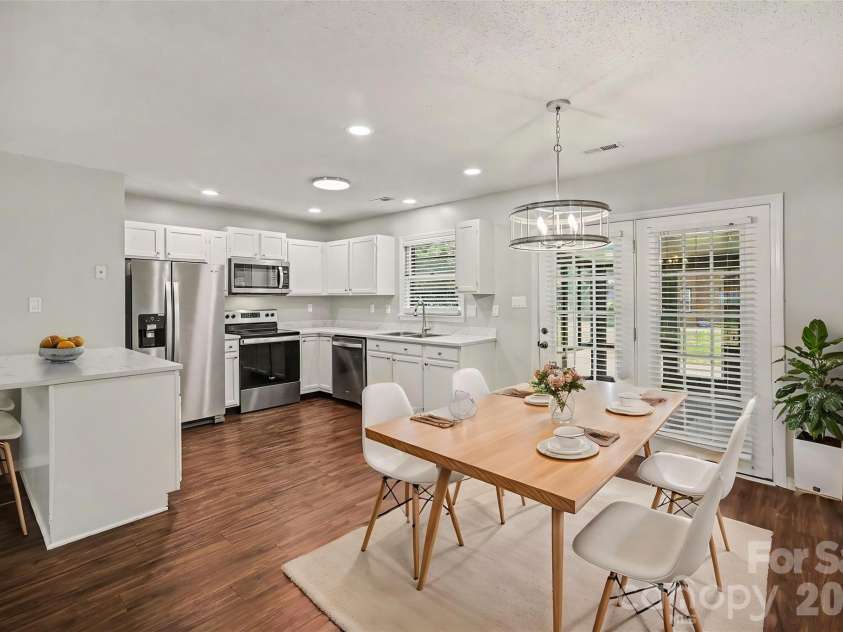 9720 Stillwater Lane, Mint Hill, NC 28227.  MLS# CAR4392489, YatesRealty ID 43501. Dining area into kitchen *Virtually Staged*