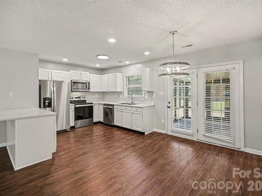 9720 Stillwater Lane, Mint Hill, NC 28227.  MLS# CAR4392489, YatesRealty ID 43501. Dining into Kitchen