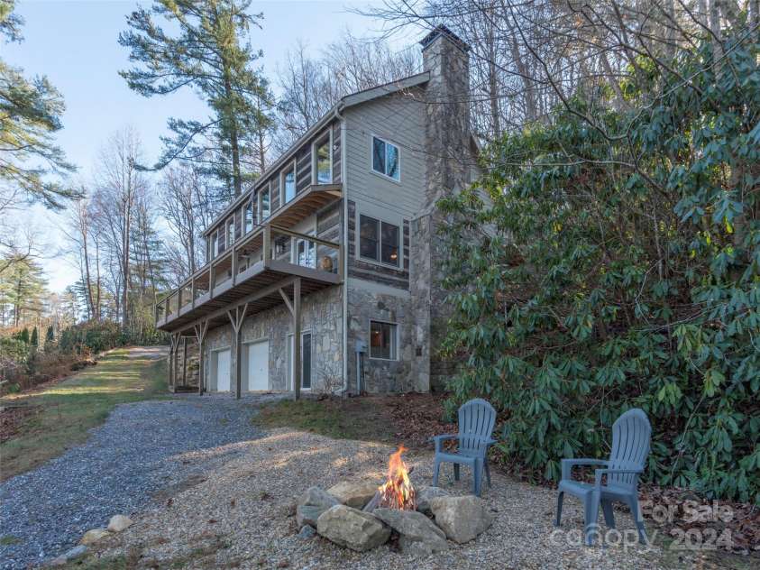 1679 Woods Mountain Trail, Cullowhee, NC 28723.  MLS# CAR4206125, YatesRealty ID 4351. Firepit adjacent to cartpath to lake