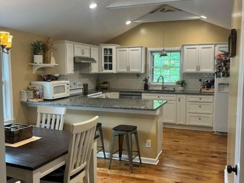 325 Ewbank Road, Etowah, NC 28729.  MLS# CAR4411444, YatesRealty ID 43546. VIEW OF OPEN PLAN KITCHEN & DINING